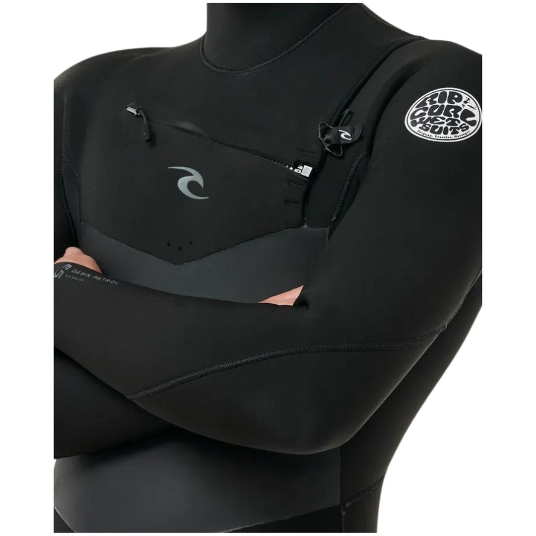 A male model wearing a Rip Curl Dawn Patrol 5/4mm black mens hooded wetsuit with a chest zip feature and yulex rubber. Close up view of the chest zip entry 